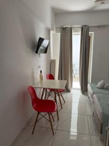 a room with a table and two chairs and a bed at Zachos studio in Heraklio