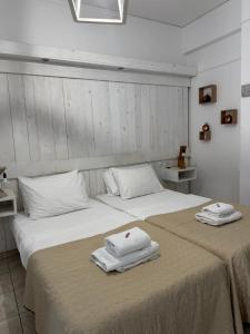 a bedroom with two beds with towels on them at Zachos studio in Heraklio