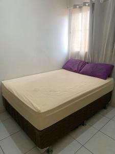 a bed sitting in a room with a window at Dekatana Hotel Village in Helunmahara