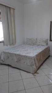 a bed sitting in a room with a window at Dekatana Hotel Village in Helunmahara