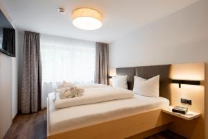 a bedroom with a large bed with a window at Aparthotel Saladina in Gaschurn +69 photos