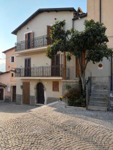 a building with a tree in front of it at Il Nespolo in Celano