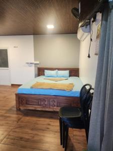 a bedroom with a bed and a chair in it at Mount View Attappadi in Agali