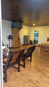 a room with a table and two chairs and a bed at Mount View Attappadi in Agali +22 photos