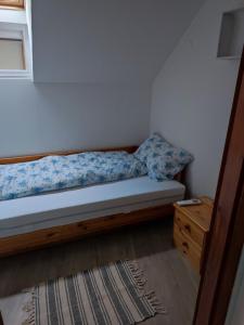 a bedroom with a bed and a dresser and a bed sidx sidx at Campana Apartment - Szigetvár in Szigetvár