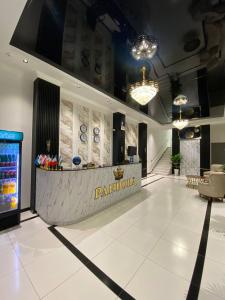 a lobby with a pantomory counter in a building at Pandora Hotel in Samarkand