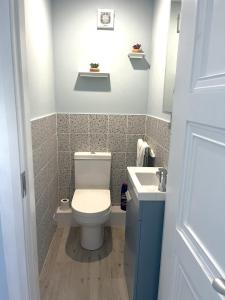 a bathroom with a toilet and a sink at Ower Retreat in Ower +28 photos