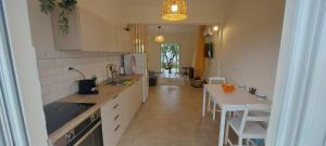 a kitchen with a counter and a table in it at Pink House Eretria in Eretria
