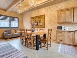 a kitchen with a table and chairs in a room at Apartamenty Bąkowo Chatka in Witów +43 photos