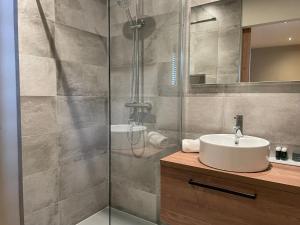 a bathroom with a sink and a shower at Hotel-restaurant "Lely" in Oude-Tonge +33 photos