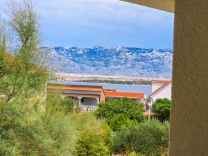 a house with a view of a lake and mountains at Apartman Adriatic View in Vir