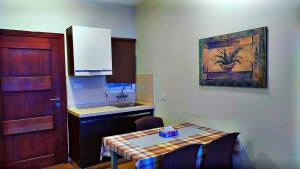 a small kitchen with a table and a sink at Luxe Villa in Murree