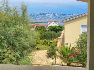 a view of a house with mountains in the background at Apartman Adriatic View in Vir
