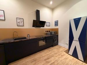 a kitchen with a counter top and a refrigerator at The Holyrood Mega-Quarters in Edinburgh