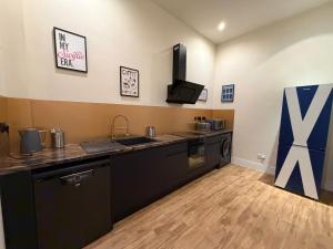 a kitchen with a sink and a counter top at The Holyrood Mega-Quarters in Edinburgh