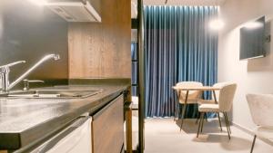 a kitchen with a sink and a table at Eden Hotel in Rrogozhinë