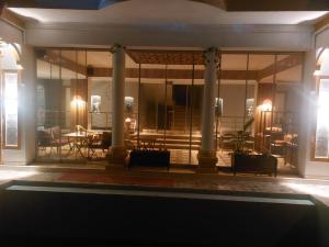 a room with glass doors and a table and chairs at dolunaydın hotel in Side