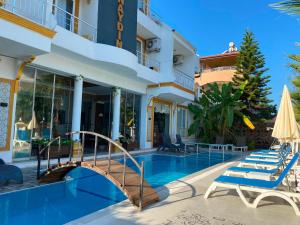 a hotel with a swimming pool and a bridge at dolunaydın hotel in Side