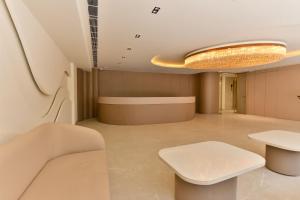 a waiting room with a bench and a table at Melange Hotel - Golf course road in Gurgaon