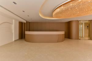a lobby with a large chandelier on the ceiling at Melange Hotel - Golf course road in Gurgaon