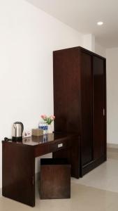 a wooden desk in a room with a large cabinet at Hila Hotel Vạn Ninh in Vạn Ninh