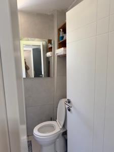a bathroom with a white toilet and a mirror at Bella Vista Apartment in Lezhë +11 photos