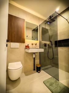 a bathroom with a toilet and a sink and a shower at Blossom Bliss in La Norville
