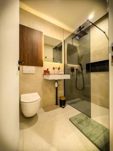 a bathroom with a toilet and a sink and a shower at Blossom Bliss in La Norville