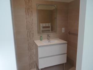 a bathroom with a sink and a mirror at Chambre Jasmin in Maubec
