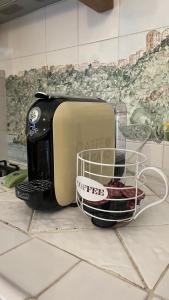 a toaster on a kitchen counter with a basket of food at Al numero 15 in Castel Gandolfo