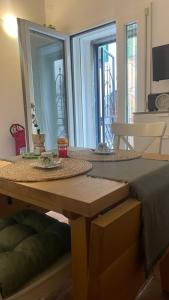 a bedroom with a table and a mirror at Al numero 15 in Castel Gandolfo