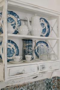 a shelf filled with blue and white plates and dishes at Villa Areto in Kamares +291 photos