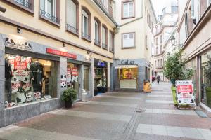 an empty street in a city with shops at Studio Pelletiers, 4 personnes – City center in Strasbourg