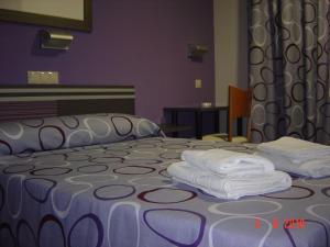 Кровать или кровати в номере Hostal Rica Posada