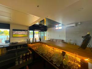 a bar with a long counter with glasses on it at Swan in Belgrade