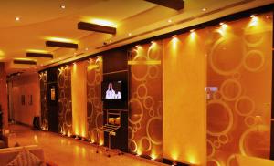 a lobby with a wall with lights on it at Nelover Hotel Hafar in Hafr Al Baten