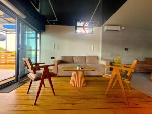 a living room with a couch and a table at Swan in Belgrade
