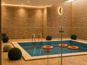 a swimming pool with three toilets in it at IQ Hotel alhamra فندق اي كيو الحمراء in Jeddah