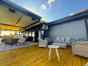 a patio with a couch and chairs and a table at Swan in Belgrade