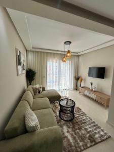 a living room with a couch and a television at Nakhla2 in Dar Bouazza