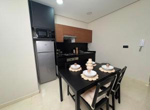a kitchen with a table with dishes on it at Nakhla2 in Dar Bouazza