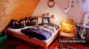 a bedroom with a bed and a chair at Potsdamer Ferienwohnung in Potsdam
