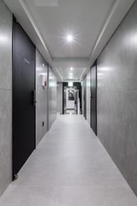 a corridor of an office building with a row of elevators at VIA jongno in Seoul