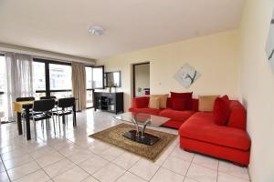 a living room with a red couch and a table at Residency by LMR in Kigali