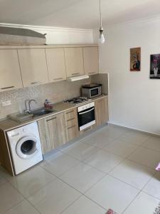 a kitchen with a sink and a washing machine at Caesar Resort spa in Dherinia