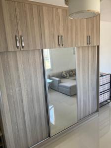 a living room with a reflection of a couch in a mirror at Caesar Resort spa in Dherinia +10 photos