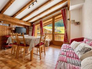 a living room with a table and chairs and a balcony at Chaleureux appartement au pied des pistes avec parking et animaux admis - FR-1-505-65 in Notre-Dame-de-Bellecombe