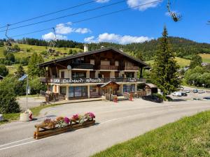 a large building on the side of a road at Chaleureux appartement au pied des pistes avec parking et animaux admis - FR-1-505-65 in Notre-Dame-de-Bellecombe