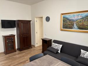 a living room with a couch and a painting on the wall at Residenza Vignoli Seregno Centro in Seregno