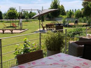 a garden with a picnic table and an umbrella at Les Loges Du Ried in Marckolsheim
